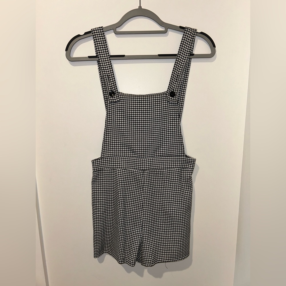 Black and white houndstooth overall shorts.